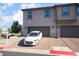Modern townhome with two-car garage and driveway featuring a parked white car at 756 Sleeping City Ave, Henderson, NV 89015