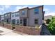 Two-story townhouse boasts a neutral exterior, front yard with brick accents, and a well-maintained landscape at 756 Sleeping City Ave, Henderson, NV 89015