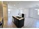 Modern kitchen features a stylish island, stainless steel appliances, tile floors, and an open layout to the living area at 756 Sleeping City Ave, Henderson, NV 89015