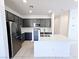 Modern kitchen featuring sleek cabinets, stainless steel appliances, quartz countertops, and tile backsplash at 756 Sleeping City Ave, Henderson, NV 89015
