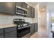 Kitchen with stainless steel gas range, gray cabinets, and a herringbone tile backsplash, providing a contemporary feel at 756 Sleeping City Ave, Henderson, NV 89015