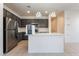 Stylish kitchen with gray cabinets, stainless steel appliances, and a center island with modern pendant lighting at 756 Sleeping City Ave, Henderson, NV 89015