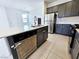 Kitchen island featuring a stainless steel dishwasher, sink, seating, and modern finishes, perfect for entertaining at 756 Sleeping City Ave, Henderson, NV 89015