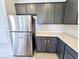 Modern kitchen featuring stainless steel appliances, quartz countertops, gray cabinetry, and tile flooring at 756 Sleeping City Ave, Henderson, NV 89015
