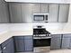 Updated kitchen featuring stainless steel appliances, quartz countertops, stylish cabinets, and tile backsplash at 756 Sleeping City Ave, Henderson, NV 89015