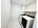 Laundry room with tile flooring and new, modern washer and dryer at 756 Sleeping City Ave, Henderson, NV 89015