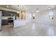 Bright and open living room and kitchen with stainless steel appliances and tile flooring throughout at 756 Sleeping City Ave, Henderson, NV 89015