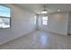 Bright living room with tile flooring, modern ceiling fan, and multiple windows allowing natural light at 756 Sleeping City Ave, Henderson, NV 89015