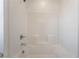 Bright white tiled shower and bathtub combo features a shower head and faucet at 756 Sleeping City Ave, Henderson, NV 89015