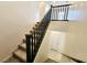 Carpeted staircase with dark railing, offering access to the upper and lower levels of the home at 756 Sleeping City Ave, Henderson, NV 89015