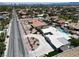 Expansive aerial view of a home with a circular driveway, lush landscaping, and refreshing swimming pool at 7575 Coley Ave, Las Vegas, NV 89117