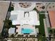 An aerial view highlighting the circular driveway, lush lawn, refreshing pool, and outdoor living space at 7575 Coley Ave, Las Vegas, NV 89117