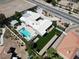 This aerial shot showcases a home with impeccable landscaping, a circular driveway, and a sparkling pool at 7575 Coley Ave, Las Vegas, NV 89117