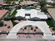 Stunning aerial view of a modern home with lush landscaping, a pool, and a circular driveway at 7575 Coley Ave, Las Vegas, NV 89117