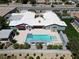Aerial view of a home featuring a refreshing swimming pool, complemented by an outdoor structure and lush landscaping at 7575 Coley Ave, Las Vegas, NV 89117