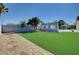 A beautiful backyard featuring an artificial lawn and a decorative concrete wall feature at 7575 Coley Ave, Las Vegas, NV 89117