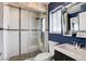Sleek bathroom boasts tiled shower with a glass door, floating vanity, and modern fixtures at 7575 Coley Ave, Las Vegas, NV 89117
