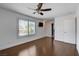 Light-filled bedroom with hardwood floors, ceiling fan, and access to ensuite bathroom, perfect for relaxation at 7575 Coley Ave, Las Vegas, NV 89117