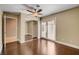 Bedroom featuring dark floors, ceiling fan, closet with mirrored doors, and doors that open to the outside at 7575 Coley Ave, Las Vegas, NV 89117