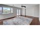 Open bedroom with modern ceiling fan, wood floors, rug, and access to an outdoor pool area at 7575 Coley Ave, Las Vegas, NV 89117