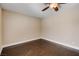 Cozy bedroom features dark wood floors, neutral walls, and a ceiling fan for added comfort and style at 7575 Coley Ave, Las Vegas, NV 89117
