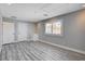 Bedroom with wood floors, a window with shutters, and two doors at 7575 Coley Ave, Las Vegas, NV 89117