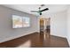 Bright bedroom features a ceiling fan, hardwood floors, and ensuite bathroom, offering comfort and style at 7575 Coley Ave, Las Vegas, NV 89117