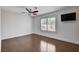 Bedroom with hardwood floors and a mounted TV, offering modern comfort and convenience at 7575 Coley Ave, Las Vegas, NV 89117