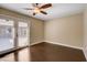 Bedroom with dark floors and a ceiling fan. The doors open to the outside and are covered by blinds at 7575 Coley Ave, Las Vegas, NV 89117