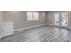 Bedroom with wood floors, a window with shutters and French doors at 7575 Coley Ave, Las Vegas, NV 89117