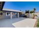 Eye-catching front yard with desert landscaping, featuring decorative palms and tile roof, providing a unique curb appeal at 7575 Coley Ave, Las Vegas, NV 89117