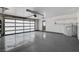 Spacious garage with epoxy flooring, shelves, and modern glass and metal garage door at 7575 Coley Ave, Las Vegas, NV 89117