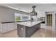 The bright kitchen has a stainless steel hood, cooktop, and a large island with white countertops at 7575 Coley Ave, Las Vegas, NV 89117