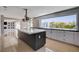 Modern kitchen with a large island, granite countertops, stainless steel appliances, and an oversized window at 7575 Coley Ave, Las Vegas, NV 89117