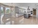 Open kitchen features granite counters, tile backsplash, stainless appliances, and seamless flow to living areas at 7575 Coley Ave, Las Vegas, NV 89117