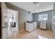 Well-equipped laundry room with washer, dryer, built-in storage, and backyard views at 7575 Coley Ave, Las Vegas, NV 89117
