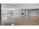 Open living area with high ceilings, tile floors, and modern lighting at 7575 Coley Ave, Las Vegas, NV 89117