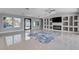 Modern living room featuring a built-in entertainment center, tile floors and access to outdoor space at 7575 Coley Ave, Las Vegas, NV 89117