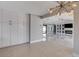 Open-concept living area featuring built-in shelves, a modern fireplace, and tile flooring at 7575 Coley Ave, Las Vegas, NV 89117