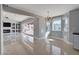 Bright living room with sleek tile flooring, a modern fireplace, and views of the backyard at 7575 Coley Ave, Las Vegas, NV 89117