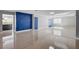 Stylish living room featuring a bold accent wall, tile flooring, and modern finishes at 7575 Coley Ave, Las Vegas, NV 89117
