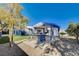 Outdoor kitchen and BBQ area with a covered patio and a lush landscaped yard at 7575 Coley Ave, Las Vegas, NV 89117