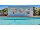 Modern pool design features framed windows with decorative statues and tropical palm trees at 7575 Coley Ave, Las Vegas, NV 89117