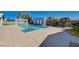 A beautiful backyard pool area with mature landscaping and a modern privacy wall at 7575 Coley Ave, Las Vegas, NV 89117