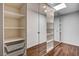 Walk-in closet featuring a skylight and built-in shelves behind mirrored doors at 7575 Coley Ave, Las Vegas, NV 89117
