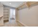 A walk-in closet has built in shelves, multiple racks, and leads into a room with a window at 7575 Coley Ave, Las Vegas, NV 89117