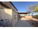 Side view of backyard with patio, shed, desert landscaping, and mature trees at 7611 Avila Beach Ave, Las Vegas, NV 89113