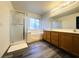 Primary bathroom features a double sink vanity and a tub/shower with glass enclosure at 7611 Avila Beach Ave, Las Vegas, NV 89113