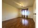 Spacious bedroom featuring hardwood floors, neutral walls, and a window at 7611 Avila Beach Ave, Las Vegas, NV 89113