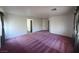 Bright and open carpeted bonus room with neutral walls shows access to the adjacent rooms at 7611 Avila Beach Ave, Las Vegas, NV 89113